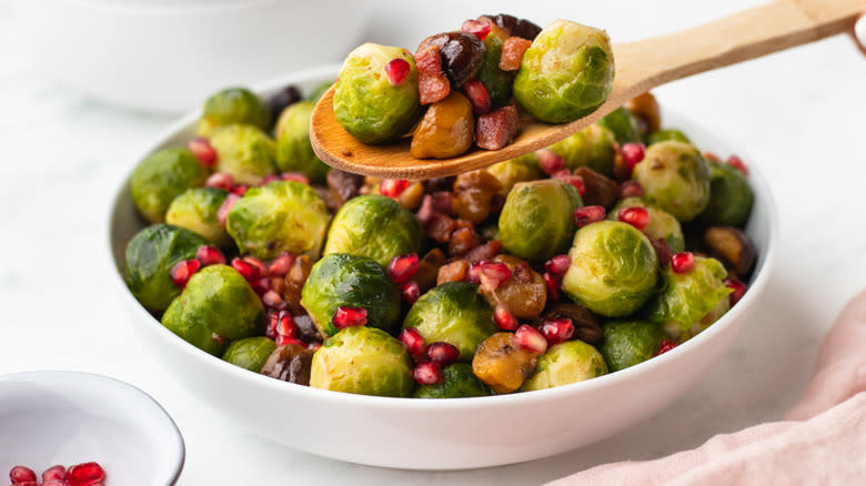Brussels sprouts being spooned out of bowl