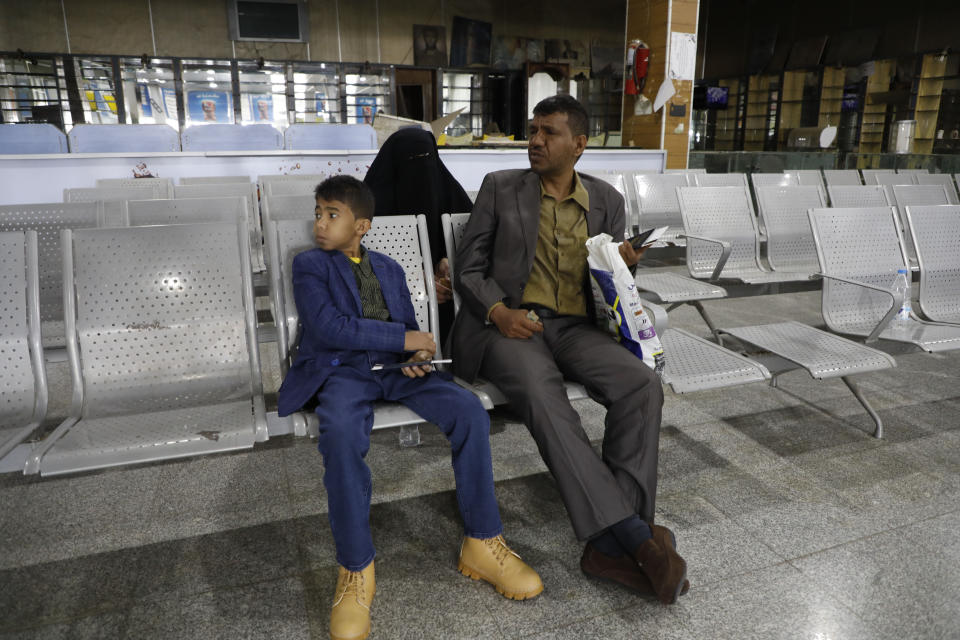 People wait in the departure lounge at Sanaa International airport for a U.N. flight, in Sanaa, Yemen, Monday, Feb. 3, 2020. The United Nations medical relief flight carrying patients from Yemen's rebel-held capital was the first in over three years. The U.N. said eight patients and their families were flown to Egypt and Jordan to receive “life-saving specialized care not available in Yemen." (AP Photo/Hani Mohammed)