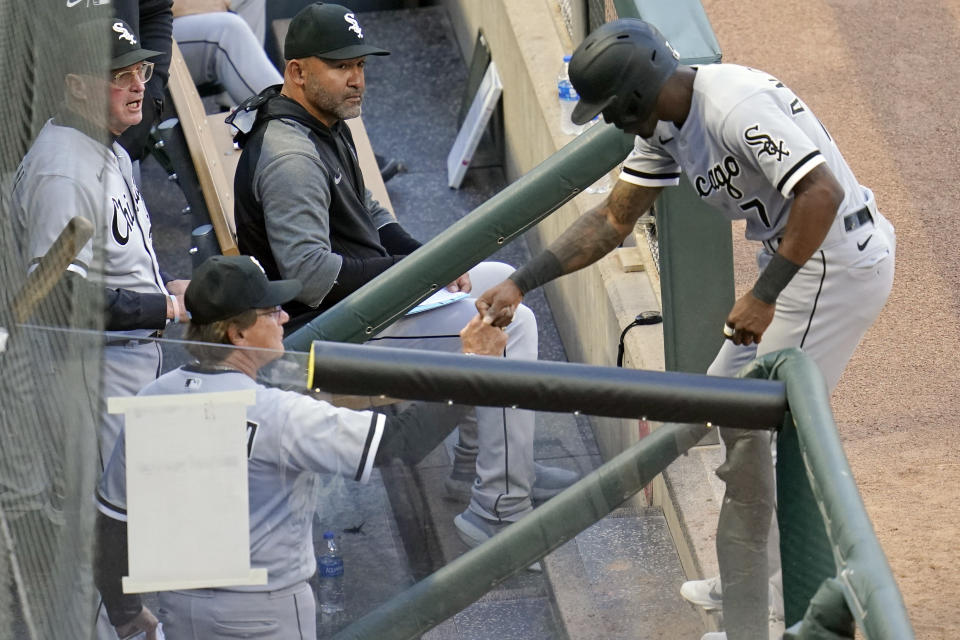 Chicago White Sox's Tim Anderson, right, is congratulated in the dugout by manager Tony La Russa after he scored on a double by Nick Madrigal off Minnesota Twins' pitcher J.A. Happ in the fourth inning of a baseball game, Monday, May 17, 2021, in Minneapolis. (AP Photo/Jim Mone)