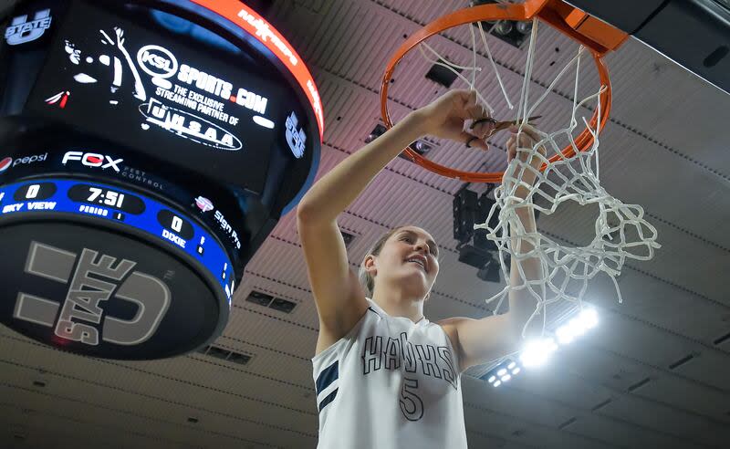 Ridgeline's Emilee Skinner cuts down the net after winning the Utah 4A girls basketball championship on Saturday in Logan. | Eli Lucero, Herald Journal