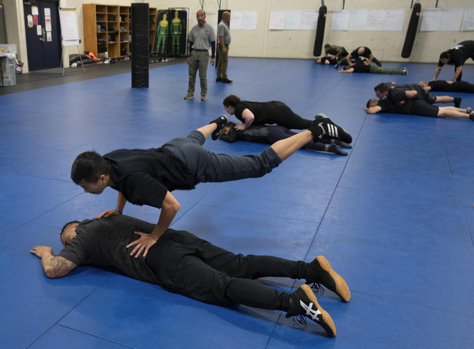 Students practice a maneuver on fellow students during an Arrest & Control Instructor course in Sacramento, Calif., on Thursday, Jan. 18, 2024. Law enforcement officers from various agencies attend the class where they receive instruction on basic techniques of arrest and control that they to take back to their agencies to pass along to fellow officers. (AP Photo/Rich Pedroncelli)