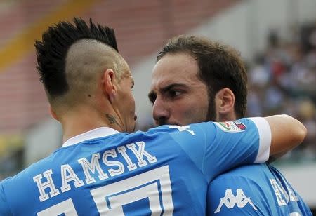 Napoli's Gonzalo Higuain (R) is celebrated by teammate Marek Hamsik after scoring against Fiorentina during their Italian Serie A soccer match at the San Paolo stadium in Naples, Italy, October 18, 2015. Napoli won 2-1.REUTERS/Ciro De Luca