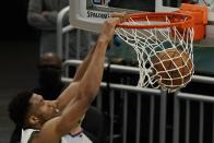 Milwaukee Bucks' Giannis Antetokounmpo dunks during the first half of an NBA basketball game against the Denver Nuggets Tuesday, March 2, 2021, in Milwaukee. (AP Photo/Morry Gash)