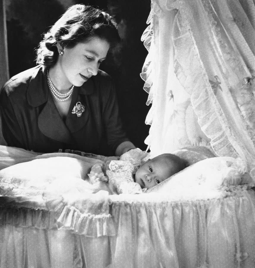 The queen-to-be becomes a mom! Princess Elizabeth admires her firstborn son, Prince Charles Arthur George of Edinburgh, at Buckingham Palace on Dec. 23, 1948. The prince was born one month earlier on Nov. 14.