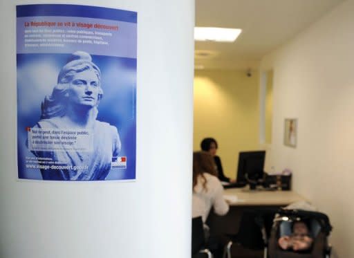 A French Republic poster informs public utility services users of the ban prohibiting full-face veils in public, in a family allowance fund agency in the French southeastern city of Lyon