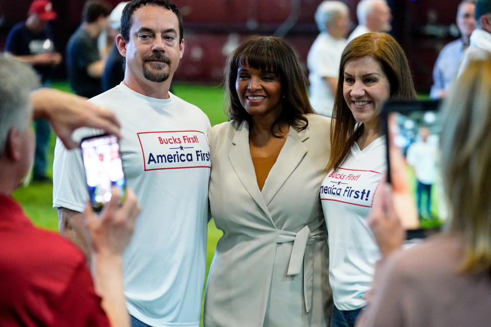 Kathy Barnette poses for a photo with two attendees at a candidate forum in Newtown, Pa., on May 11.