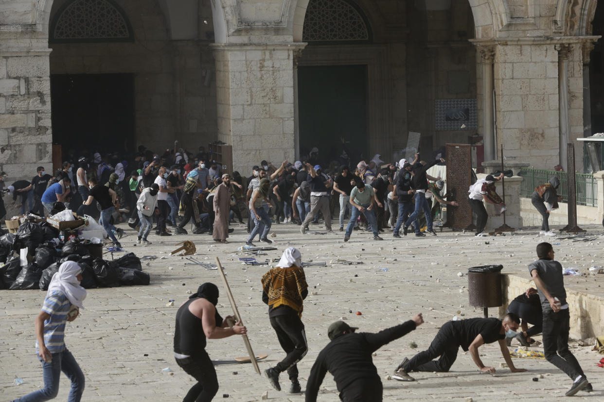 Palestinians clash with Israeli security forces at the Al Aqsa Mosque compound in Jerusalem's Old City Monday, May 10, 2021. Israeli police clashed with Palestinian protesters at a flashpoint Jerusalem holy site on Monday, the latest in a series of confrontations that is pushing the contested city to the brink of eruption. Palestinian medics said at least 180 Palestinians were hurt in the violence at the Al-Aqsa Mosque compound, including 80 who were hospitalized. (AP Photo/Mahmoud Illean)