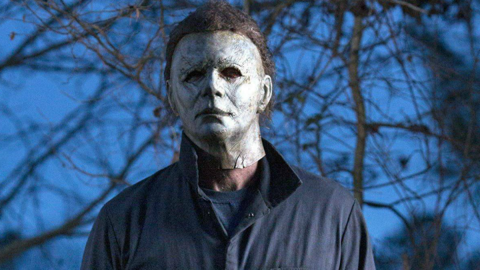 Michael Myers stands outside looking creepy and not holding his horror weapon knife, one of the best in the genre