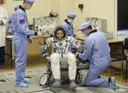 Russian Space Agency experts help CSA astronaut David Saint Jacques, member of the main crew of the expedition to the International Space Station (ISS), during the inspection of his space suit prior the launch of Soyuz MS-11 space ship at the Russian leased Baikonur cosmodrome, Kazakhstan, Monday, Dec. 3, 2018. (AP Photo/Dmitri Lovetsky)