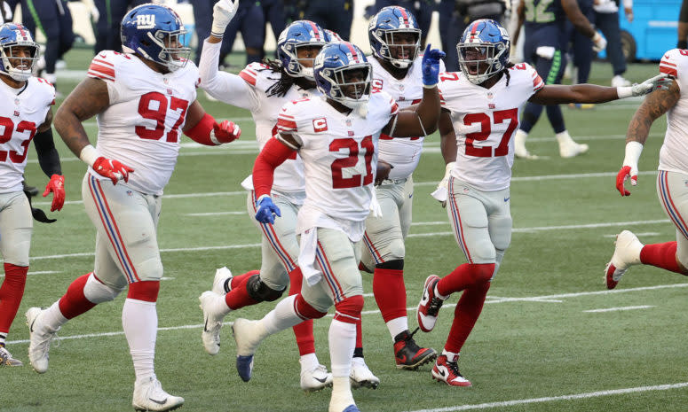 Giants players celebrate on the field in Seattle.