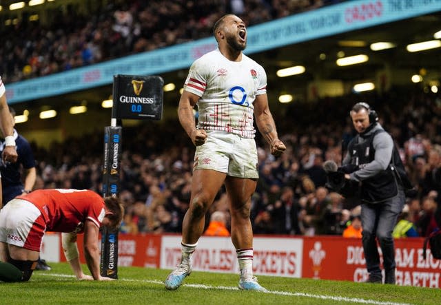 England’s Ollie Lawrence celebrates scoring a try against Wales