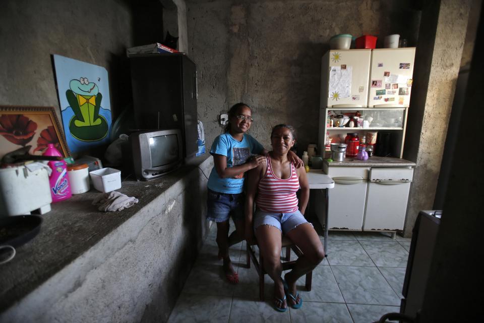 Raimunda Eliandra Alves poses with her daughter Ana Paula Leonardo Justino at their home at the Pavao-Pavaozinho slum in Rio de Janeiro