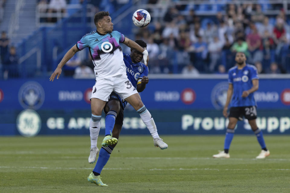 Minnesota United defender Zarek Valentin (3) wins a header against CF Montreal midfielder Victor Wanyama during first-half MLS soccer match action in Montreal, Saturday, June 10, 2023. (Evan Buhler/The Canadian Press via AP)