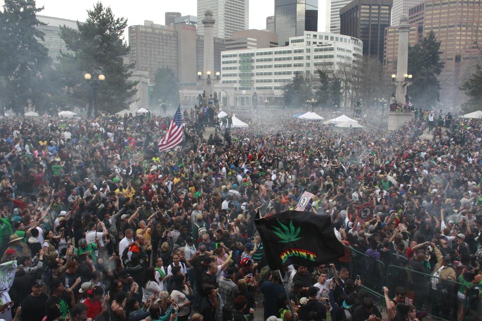 FILE - In this April 20, 2013, file photo, members of a crowd numbering tens of thousands smoke marijuana and listen to live music at the Denver 420 pro-marijuana rally at Civic Center Park in Denver. Organizers of Denver’s annual April 20 marijuana festival announced on Wednesday, April 2, 2014, that rapper B.o.B and singer Wyclif Jean will headline the event as they try draw a big post-legalization crowd and shake the memory of last year’s event, which was marred by a still-unsolved shooting. (AP Photo/Brennan Linsley, File)