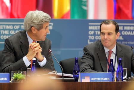 U.S. Secretary of State John Kerry speaks with Brett McGurk, Special Presidential Envoy for the Global Coalition to Counter ISIL, at the "Meeting of the Ministers of the Global Coalition to Counter ISIL: Joint Plenary Session" at the State Department in Washington, U.S., July 21, 2016. REUTERS/Joshua Roberts