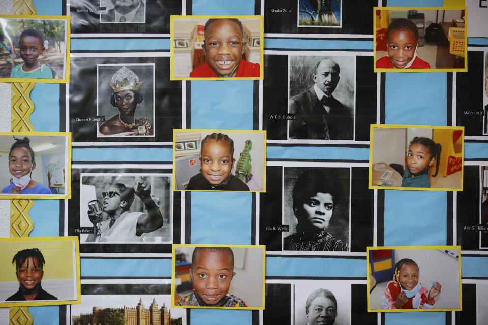 Student portraits sit amongst portraits of historical Black figures in a classroom at the Kilombo Academic and Cultural Institute, Tuesday, March 28, 2023, in Decatur, Ga. (AP Photo/Alex Slitz)