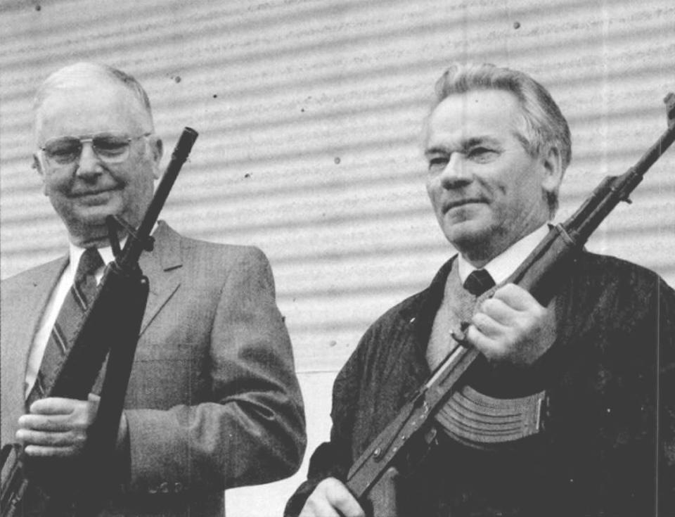 This photo from May 22, 1990, shows Eugene M. Stoner, left, and Mikhail T. Kalashnikov holding the assault rifles the other designed.