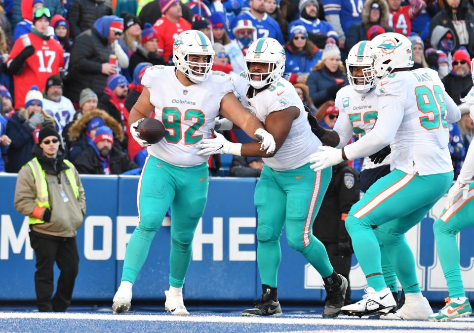 Jan 15, 2023; Orchard Park, NY, USA; Miami Dolphins defensive tackle Zach Sieler (92) recovers a fumble for a touchdown against the Buffalo Bills during the second half in a NFL wild card game at Highmark Stadium. Mandatory Credit: Mark Konezny-USA TODAY Sports