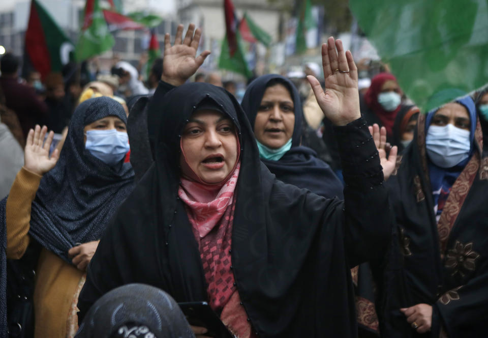 Shiite Muslims chant slogans during a sit-in to protest the killing of coal mine workers by gunmen near the Machh coal field, in Lahore, Pakistan, Wednesday, Jan. 6, 2021. Pakistan's minority Shiites continued their sit-in for a fourth straight day insisting they will bury their dead only when Prime Minister Imran Khan personally visits them to assure protection. (AP Photo/K.M. Chaudary)