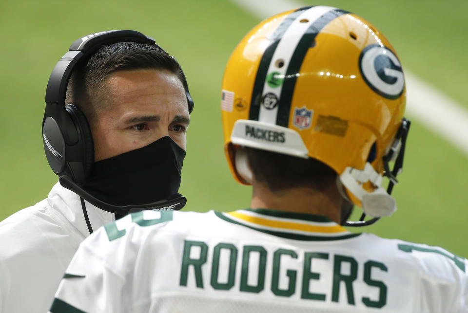 Green Bay Packers head coach Matt LaFleur, left, talks with quarterback Aaron Rodgers (12) during the first half of an NFL football game against the Minnesota Vikings, Sunday, Sept. 13, 2020, in Minneapolis. (AP Photo/Bruce Kluckhohn)