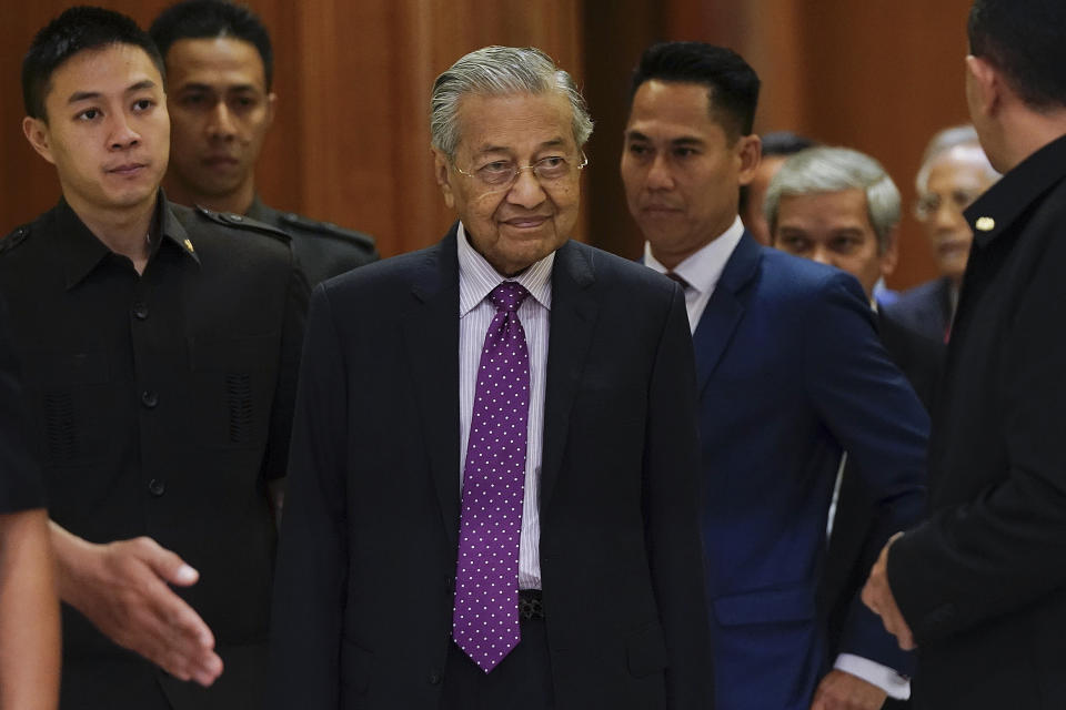 Malaysian interim leader Mahathir Mohamad, center, arrives for a press conference at his office in Putrajaya, Malaysia, Thursday, Feb. 27, 2020. Mahathir says Parliament will pick a new prime minister after the king failed to establish who has majority support following the collapse of the ruling coalition. (AP Photo/Vincent Thian)