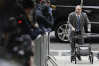 Harvey Weinstein talks to reporters as he arrives at a Manhattan courthouse for his rape trial in New York, Tuesday, Feb. 18, 2020. (AP Photo/Seth Wenig)