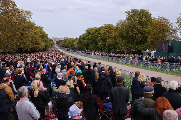 WINDSOR, ENGLAND - SEPTEMBER 19: Crowd stands for National Anthem for the Committal Service for Queen Elizabeth II on September 19, 2022 in Windsor, England. The committal service at St George's Chapel, Windsor Castle, took place following the state funeral at Westminster Abbey. A private burial in The King George VI Memorial Chapel followed. Queen Elizabeth II died at Balmoral Castle in Scotland on September 8, 2022, and is succeeded by her eldest son, King Charles III. (Photo by Richard Heathcote/Getty Images)