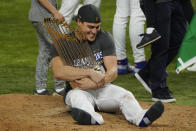 Los Angeles Dodgers second baseman Enrique Hernandez celebrates with trophy after defeating the Tampa Bay Rays 3-1 to win the baseball World Series in Game 6 Tuesday, Oct. 27, 2020, in Arlington, Texas. (AP Photo/Tony Gutierrez)