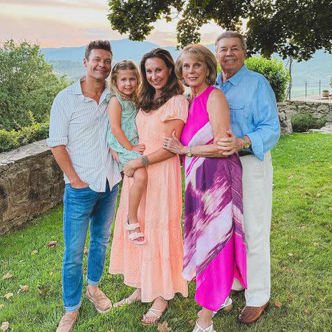 <p>Ryan Seacrest Instagram</p> Ryan Seacrest, Flora Marie Leach, Meredith Seacrest Leach, Connie Seacrest, and Gary Seacrest pose for a photo outdoors.