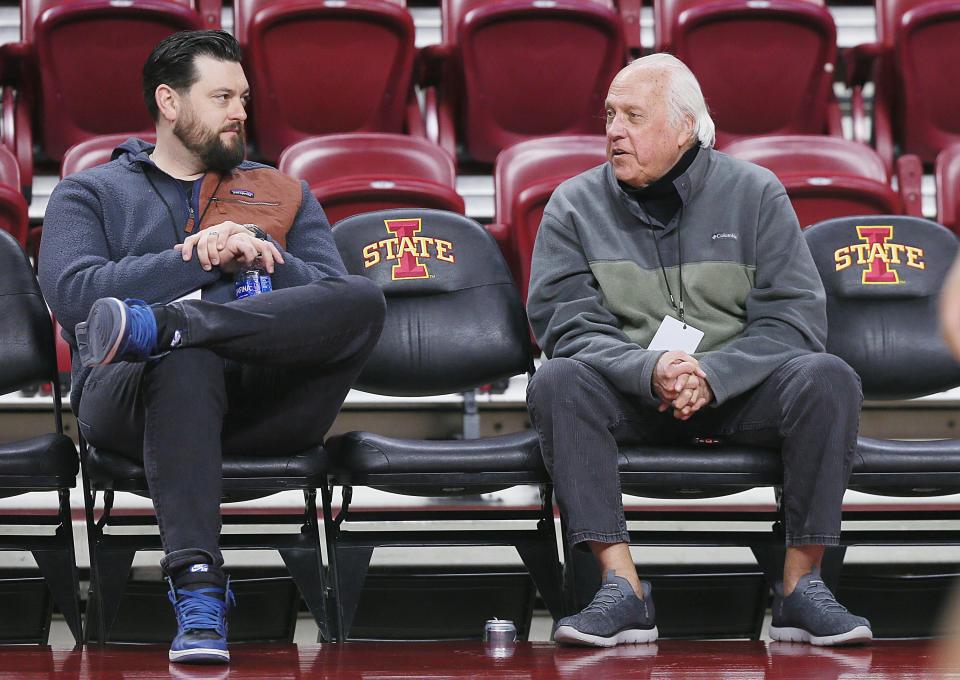 Des Moines Register columnist Randy Peterson talks to Register sports reporter Travis Hines while watching pre-game warm-ups at Hilton Coliseum.