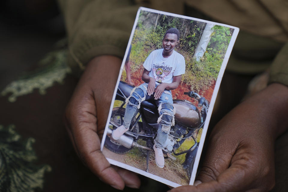 Edith Wanjiku shows a photo of his son 19-year-old Ibrahim Kamau at her home in the Majengo low-income neighborhood in Nairobi, Kenya Friday, June 28, 2024. Kamau was shot during a protest on Tuesday against the government proposed tax bill. Protesters stormed parliament on Tuesday and drew police fire in chaos that left several people dead. (AP Photo/Brian Inganga)