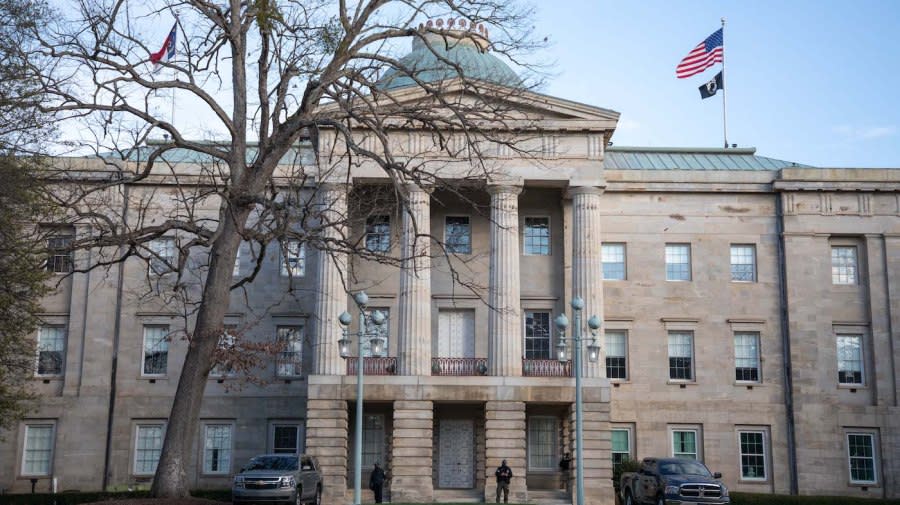 <em>Law enforcement stand guard outside of the state capitol building in downtown Raleigh, North Carolina, on January 17, 2021.</em> (Photo by LOGAN CYRUS/AFP via Getty Images)