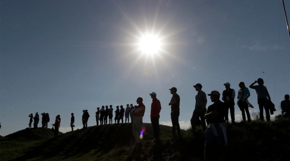 Ryder Cup spectators are silhouetted along the terrain at Whistling Straits, Friday, Sept. 24, 2021, in Haven, Wis.
