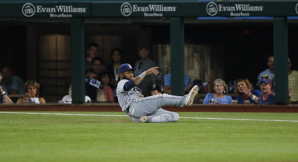 Tampa Bay Rays right fielder Manuel Margot makes a sliding catch of a flyout hit by Texas Rangers' Khris Davis during the fourth inning of a baseball game, Saturday, June 5, 2021, in Arlington, Texas. (AP Photo/Brandon Wade)