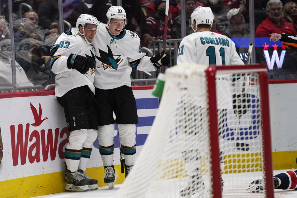 San Jose Sharks defenseman Nicolas Meloche, center, celebrates his goal with teammates Matt Nieto, left, and Andrew Cogliano during the second period of an NHL hockey game, Wednesday, Jan. 26, 2022, in Washington. (AP Photo/Evan Vucci)