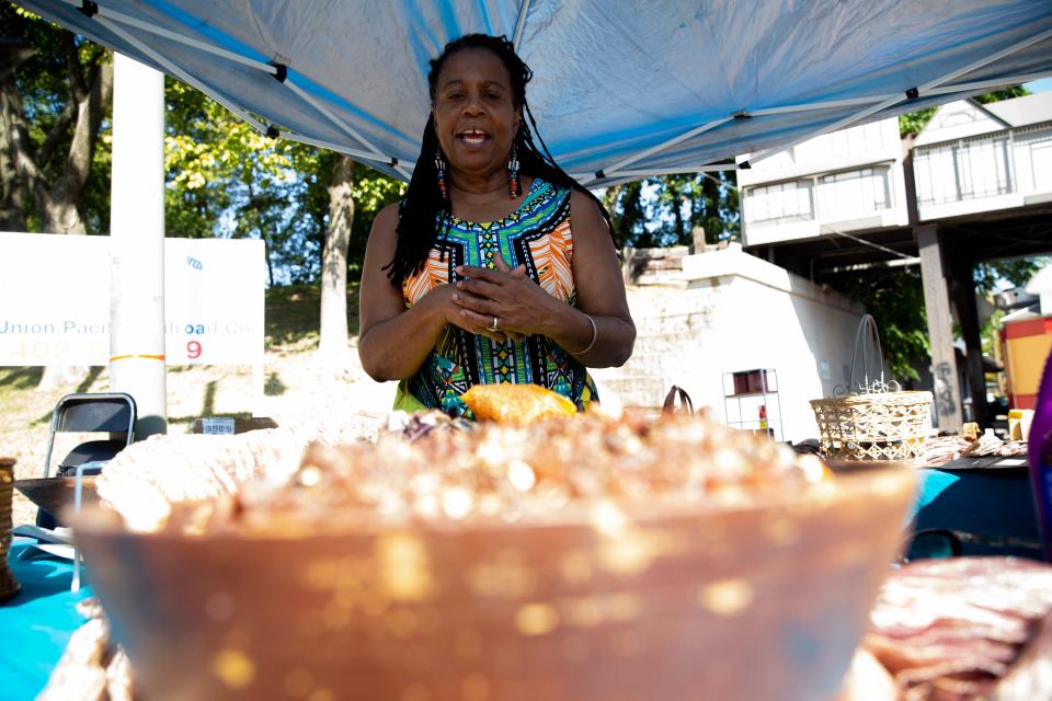 Cynthia Johnson explains the origins of her potpourri crystals at her Cynthia’s Secret Garden booth during the Cooper-Young Festival in Midtown Memphis, on Saturday, September 16, 2023.