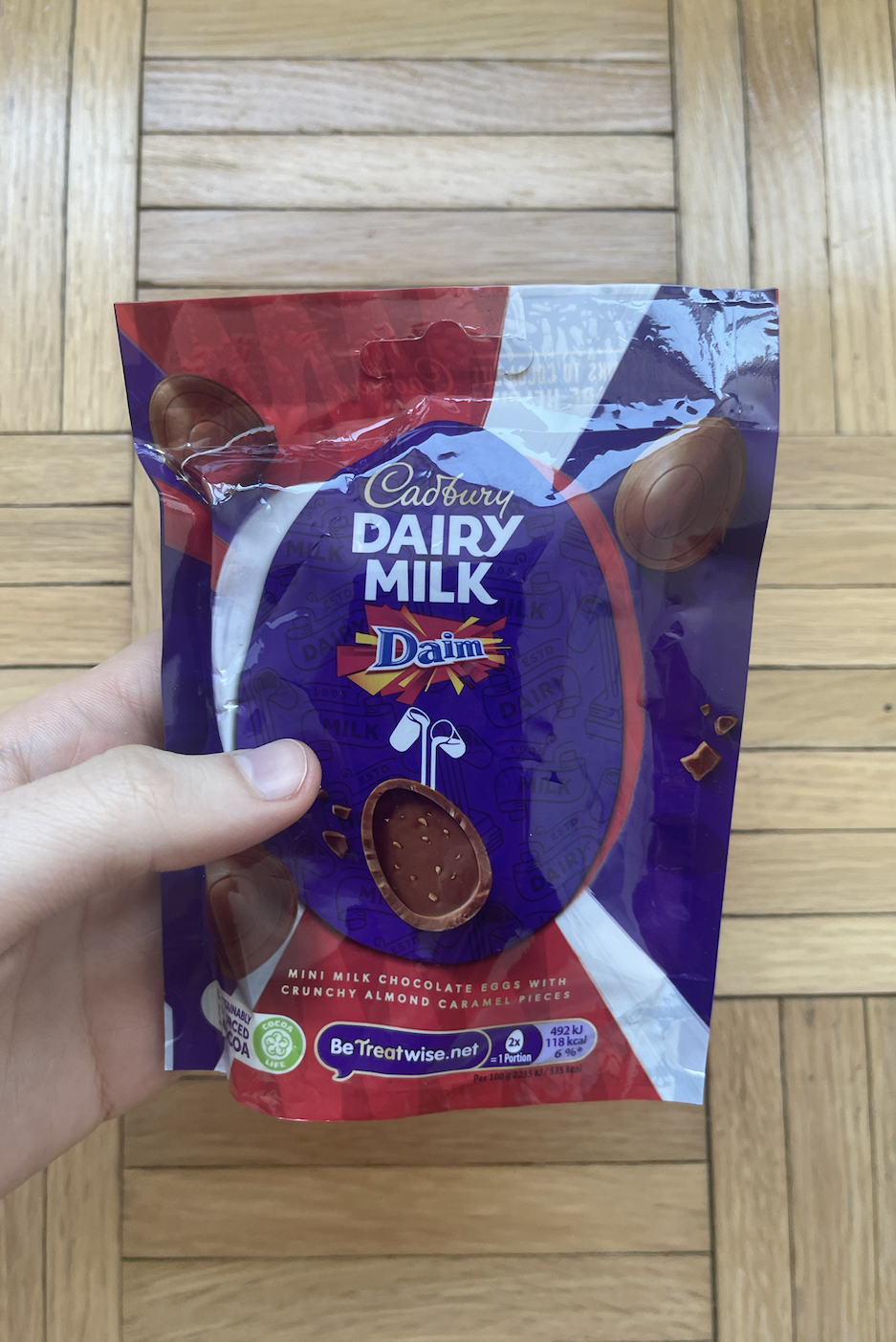 Hand holding a pack of Daim