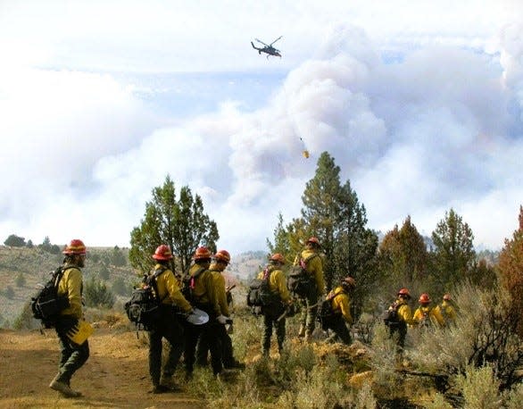 Crews work on the Falls Fire burning in Grant and Malheur counties. There were at least 14 fires burning on national forest lands in the Pacific Northwest Region on Tuesday.