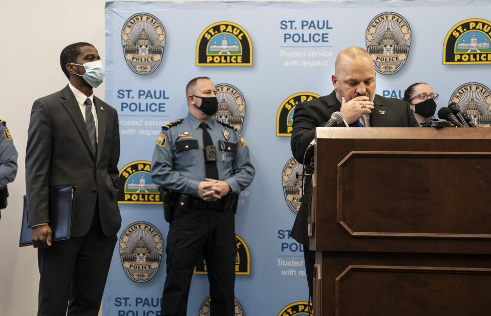 St. Paul Police Chief Todd Axtell, Mayor Melvin Carter, and other officers stood at the podium as body camera footage played for the media on televisions in the room at a press conference about a shooting by a police officer last weekend in St. Paul, Minn., on Tuesday, Dec. 1, 2020. (Renee Jones Schneider/Star Tribune via AP)