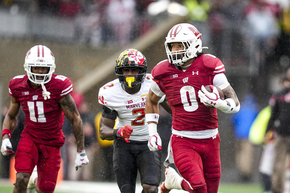 Wisconsin running back Braelon Allen (0) runs ahead of Maryland defensive back Jakorian Bennett (2) during the first half of an NCAA college football game Saturday, Nov. 5, 2022, in Madison, Wis. (AP Photo/Andy Manis)