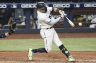 Miami Marlins' Miguel Rojas hits a two-run double during the sixth inning of the team's baseball game against the Milwaukee Brewers, Saturday, May 14, 2022, in Miami. (AP Photo/Lynne Sladky)