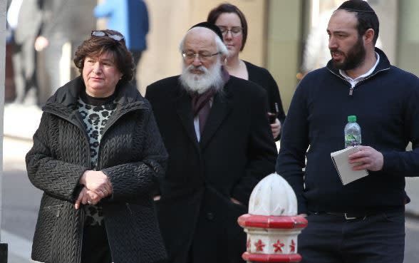 Esther and Zavy Adler and their son Chaim outside Mayor's and City County Court