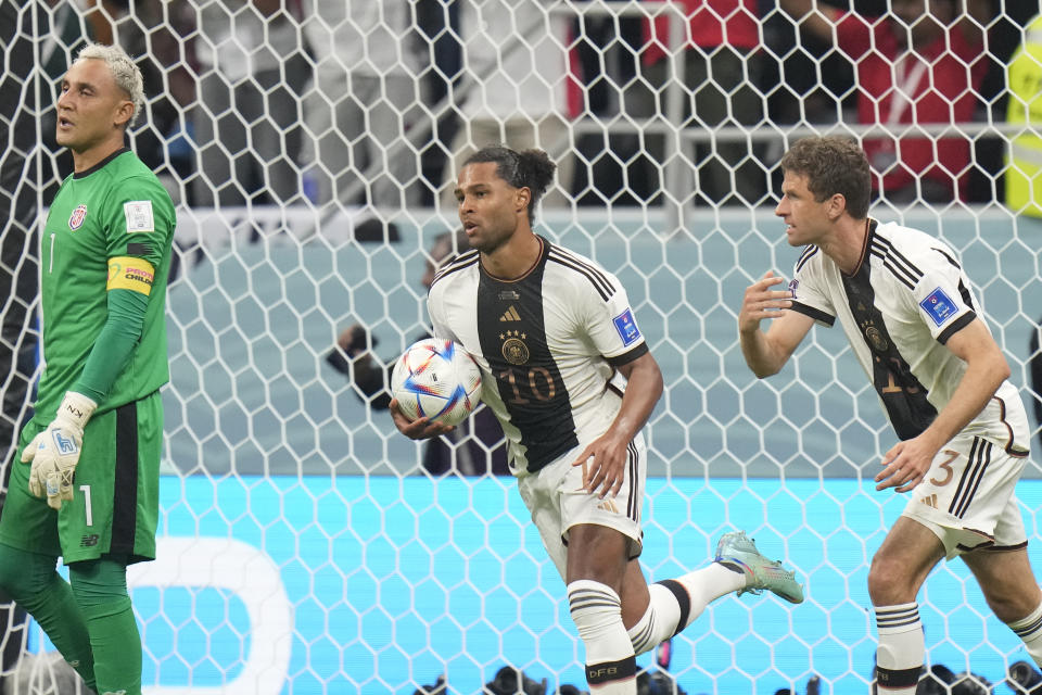 Germany's Serge Gnabry, centre, celebrates after scoring his side's opening goal during the World Cup group E soccer match between Costa Rica and Germany at the Al Bayt Stadium in Al Khor, Qatar, Thursday, Dec.1, 2022. (AP Photo/Moises Castillo)