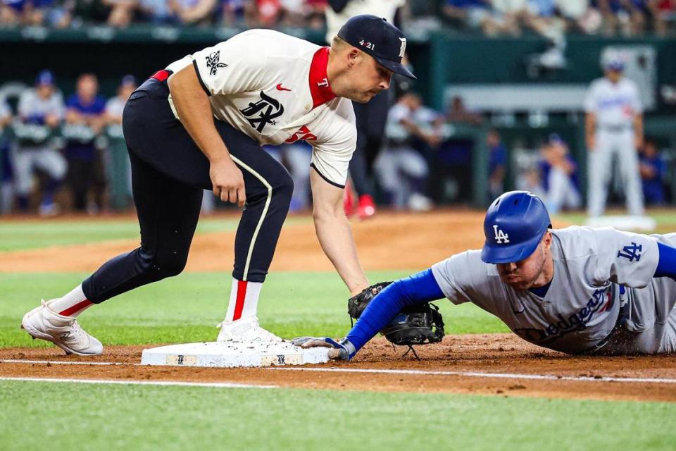 Texas Rangers infielder Nathaniel Lowe (30) attempts to pick off Los Angeles Dodgers infielder Freddie Freeman (5) in the first inning of a regular season match up against the Los Angeles Dodgers at Globe Life Field in Arlington, Texas on Saturday, July 22, 2023. The Rangers gave up 18 hits and lost 16-3.