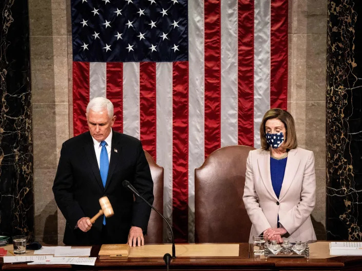 A photo of Mike Pence (left) holding a gavel and Speaker Nancy Pelosi on January 6, 2021.