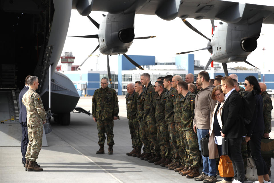 German Bundeswehr soldiers of the Headquarters initial command element of the Bundeswehr's 45th Brigade Lithuania arrive at an airport in Vilnius, Lithuania, Monday, April 8, 2024. Germany has made a commitment to deploy a heavy brigade with three maneuver battalions and all necessary enablers, including combat support and provision units, to Lithuania. In total, approx. 5 thousand German military and civilian personnel are expected to move to Lithuania with families in stationing the Brigade. (AP Photo/Mindaugas Kulbis)