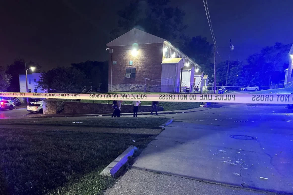 In this photo released by the Baltimore Police Department, police tape cordons off the area of a mass shooting incident in the Southern District of Baltimore, Maryland, early Sunday, July 2, 2023. (Baltimore Police Department via AP)