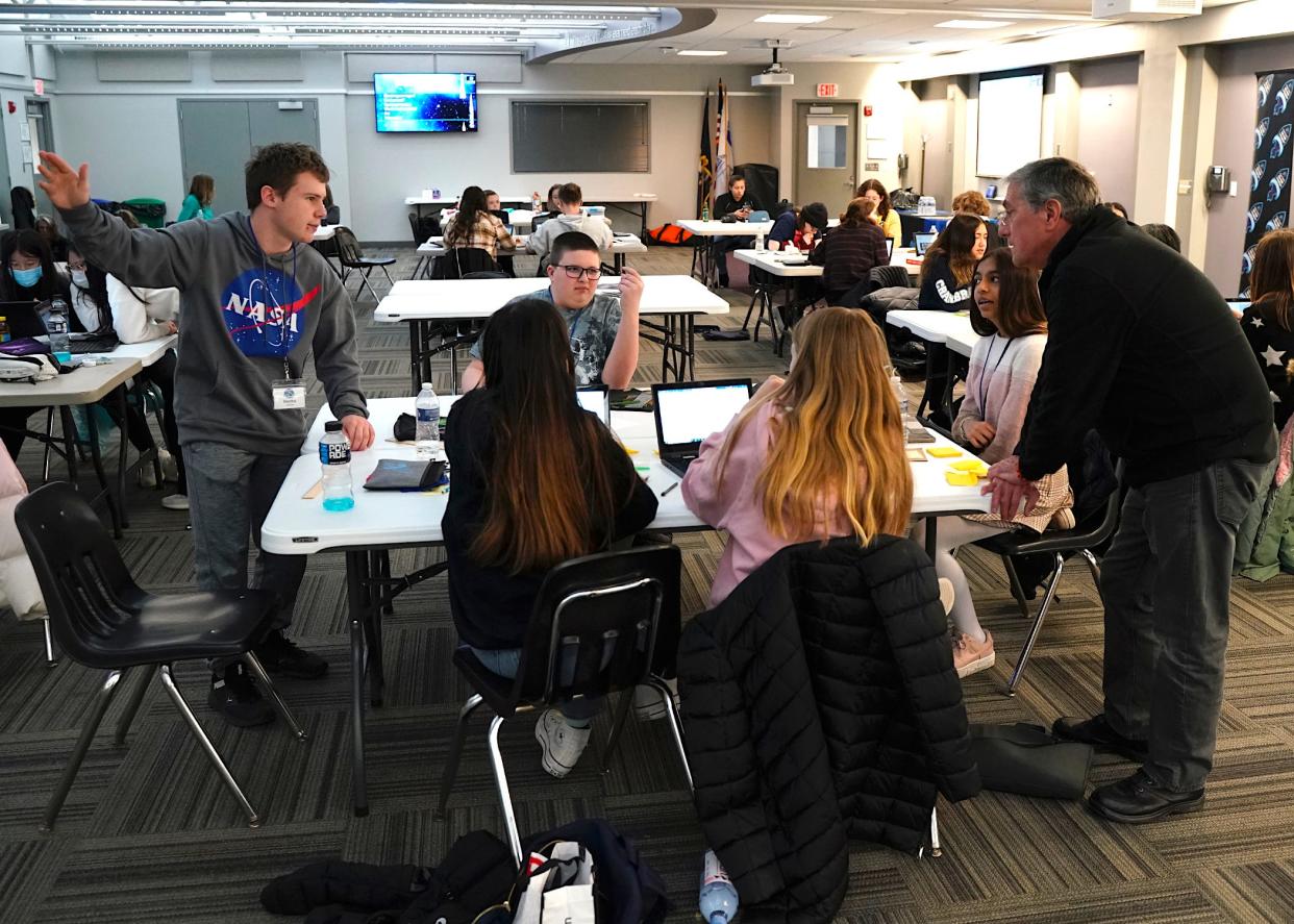 Middle and high school students, including, from left, Maddox Laskowski, a Tecumseh High School 10th grader; Thomas Norman, center, eighth grader from Springbrook Middle School in Adrian; and Jessica Jeyasingh, an eighth grader from Birmingham in Oakland County; speak with four-time space shuttle astronaut Don Thomas, right, about sodium ion batteries in space during the Higher Orbits educational program Go For Launch! Lenawee that took place Friday and Saturday in Adrian at the Lenawee Intermediate School District Tech Center.
