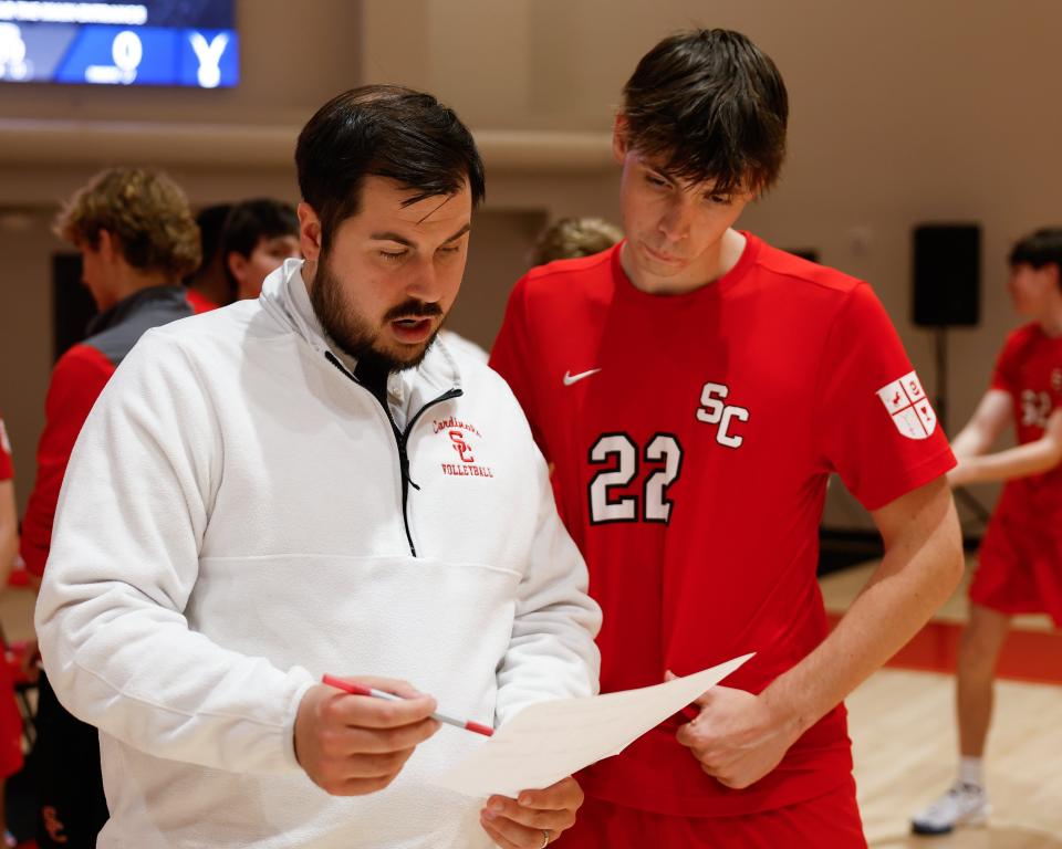 St. Charles coach Ned Gruber talks with senior setter Thomas Clark during a regional semifinal win over Hartley on May 14.