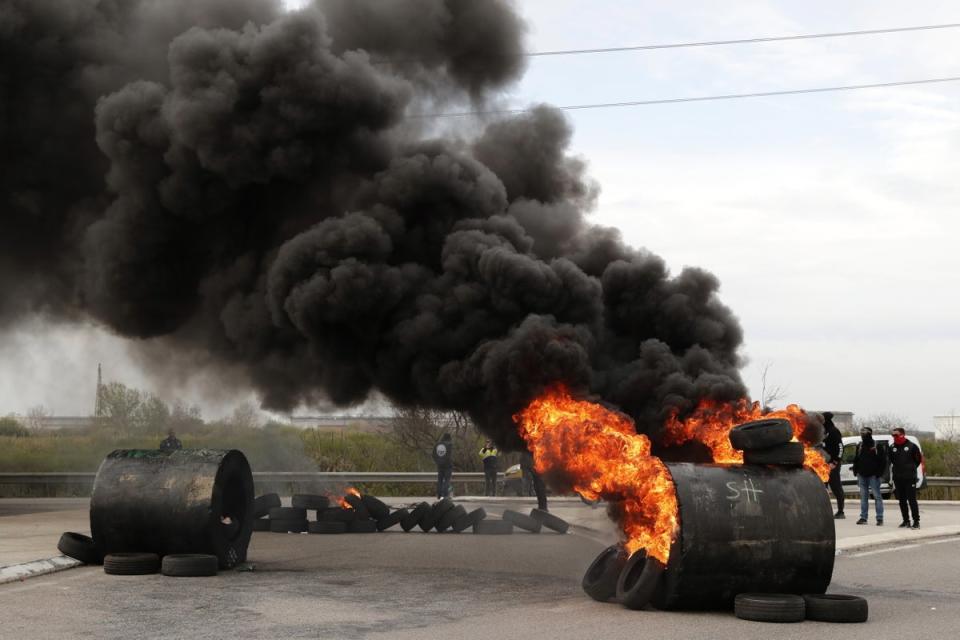 French union workers block access to the Fos-sur-Mer refinery during a protest against the French government's reform to the pension system, in Fos-sur-Mer, near Marseille (EPA)